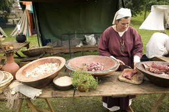 Woman cooking Historical re-enactment Saxon, Viking, Norman history, Woodbridge, Suffolk, England,