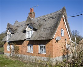 Traditional red brick thatched cottage, Sutton, Suffolk, England, United Kingdom, Europe