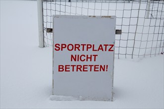 Symbolic image Football match cancellation due to snow. Sign on a sports field with the inscription