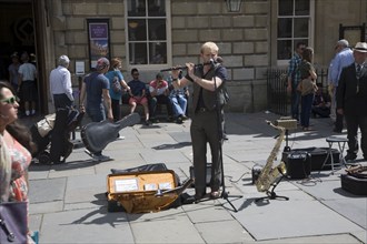 Male busker performing in Abbey churchyard, Bath, Somerset, England, United Kingdom, Europe