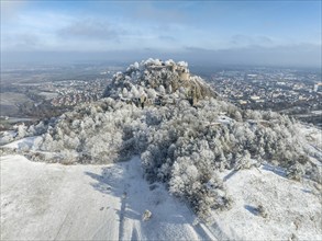 Aerial view of the snow-covered Hegau volcano Hohentwiel with Germany's largest castle ruins,