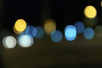 Bokeh balls, abstract dark background with blue and yellow lights, night shot, Barcelona, Spain,