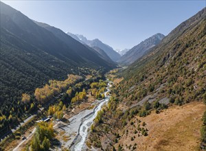 Aerial view, mountain stream Ala Archa flows through the Ala Archa valley, autumnal mountain