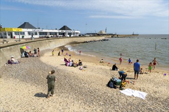 Families enjoying sunny summer weather on South Pier beach, Lowestoft, Suffolk, England, UK