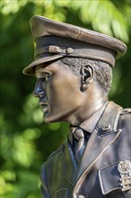 Bronze statue, monument to rock singer Elvis Presley, King of Rock 'n' Roll in uniform of the 3rd