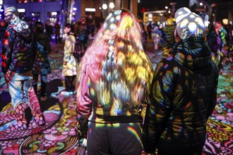 Festival of Lights, People standing at Potsdamer in a light installation, Berlin, 07.10.2024.,