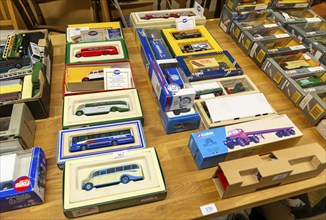 Boxes of Corgi model buses, coaches and other vehicles on display at auction, UK