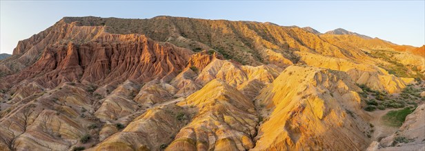 Erosion landscape of red and grey sandstone, rock formations at sunrise with sun star, Skazka