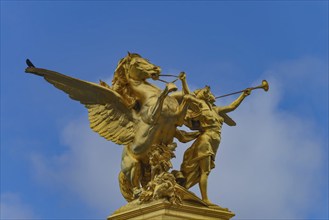 Column with the group of figures Fama of War on the Pont Alexandre III bridge over the Seine,