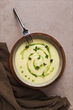 Mashed potatoes, with green butter and micro greenery, homemade, on a beige table, no people, top