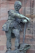 Sculpture Miner with pickaxe as a symbol of industry and mining, statue, figure, bronze, worker,