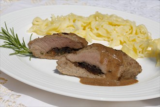 Swabian cuisine, lamb stuffed with prunes, rosemary, herbs, fillets arranged on plates,