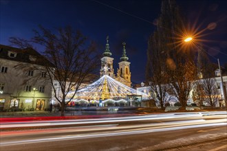 Traces of lights from car traffic, Christmas lights at the Christmas market, Mariahilferkirche at