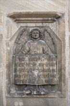 Angel figure with inscription plaque at St George's Church, Dinkelsbühl, Bavaria, Germany, Europe