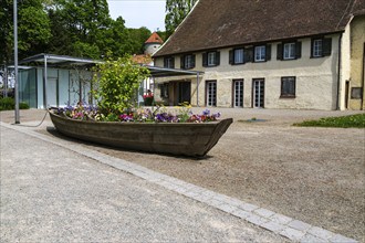 Old historic barge converted into a colourful flower bed in the Badgarten Überlingen,