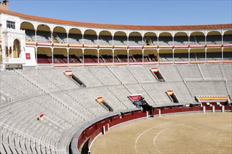 Madrid, Spain, Europe, Spacious rows of seats in a bullring, partly decorated with Spanish flags,