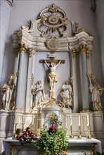 The side altar of the Catholic parish church of St. Johannes Baptist, showing statuesof the saints