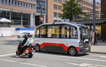 Hamburg, Germany - Autonomous elevated railway electric bus and an Emmy electric scooter in