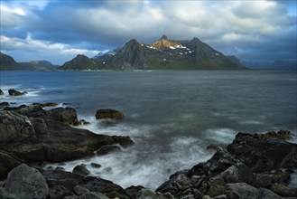 Landscape with sea and mountains on the Lofoten Islands, view across the fjord to the small town of