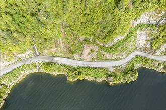 Road Carretera Austral winding along the fjord south of village Puyuhuapi, Patagonia, Chile, South