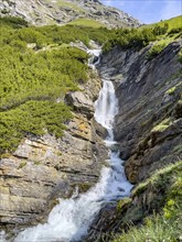 Waterfall in the Braulio valley Cascata del Braulio with little water in midsummer alpine summer in