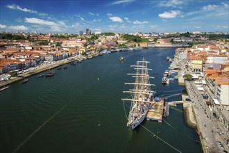 Aerial view of Porto city and Vila Nova de Gaia and Douro river with moored sailling ship from Dom