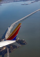 San Francisco, California, A Southwest Airlines plane flies over Yerba Buena Island and the San