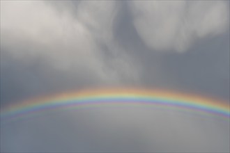 Rainbow appears in rain clouds in spring. Bas Rhin, Alsace, France, Europe