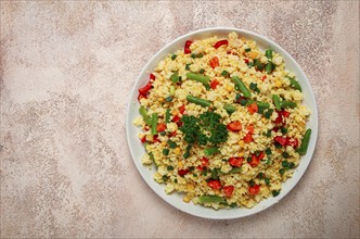 Couscous with vegetables, paprika, carrots, string beans, corn, homemade, top view, no people