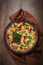 Couscous with vegetables, paprika, carrots, string beans, corn, homemade, top view, no people