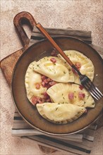 Dumplings, with fried prosciutto, a traditional dish of Polish cuisine, dumplings, top view,