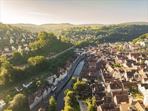 Small town with river, surrounded by hills and forests, taken from the air on a sunny day, Calw,