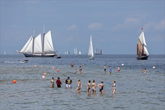 Sailing ships, sailing boats, people standing in the water, Kieler Woche, Kiel Fjord, Kiel,