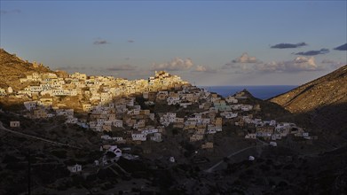 View of a hilltop town, illuminated by the morning sun, Colourful mountain village, Morning light,