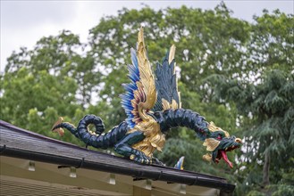 Close-up of a gold-blue-red painted dragon statue, historic large pagoda, Royal Botanic Gardens