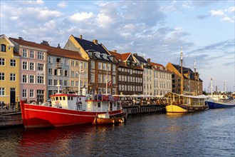 Colourful houses, restaurants and historic ships on the Nyhavn canal and harbour, Copenhagen,