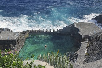 An oceanfront swimming area surrounded by rocks and waves, Charco Azul, San Andres, La Palma,