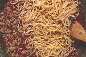 Spaghetti Bolognese, top view, in a frying pan, close-up, without people, homemade