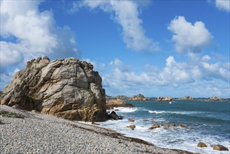 Coast with big rocks and blue sky, calm sea waves on a sunny day, Plage de Pors Scaff,