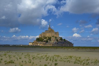 Picturesque view of Mont Saint-Michel on an island with medieval architecture, summer, Le