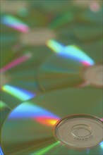 Several CD-ROMs with rainbow effect on the surface, close-up