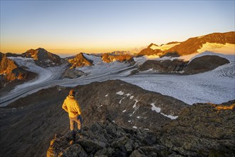 Mountaineer at the summit of the Becher, view of high mountain landscape with glacier