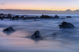 Rocks and sea on the beach of Playa del Inglés at sunset. Long exposure. Valle Gran Rey, La Gomera,