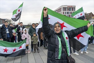 Syrian woman celebrate the end of the Assad regime after the change of power in Syria at a rally on