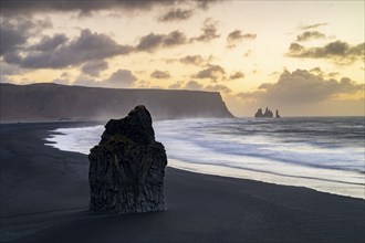 View from Cape Dyrhólaey at sunrise, rock formations Reynisdrangar and the mountain Reynisfjall,