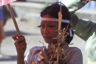 Ngaben (cremation ceremony), at the cremation site woman carry the remains of a family member from