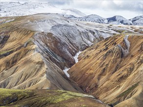 Early snow on the colorful rhyolite mountains, Landmannalaugar, Fjallabak Nature Reserve, Iceland,