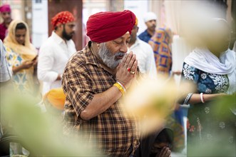 Sikh devotees offer prayers at a Gurudwara on the occasion of Guru Nanak Jayanti, in Guwahati,