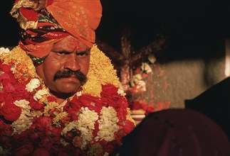 Healing session led by a hindu man, portrait of a traditional healer at work, Chittorgarh,