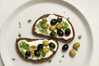 Breakfast, sandwiches, with cream cheese, olives, top view